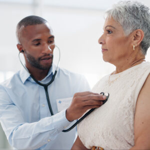 Stethoscope, examination and doctor with senior woman at hospital for lungs, chest or breathing assessment. Heart, listen and elderly patient consulting cardiologist for heartbeat, pulse or checkup